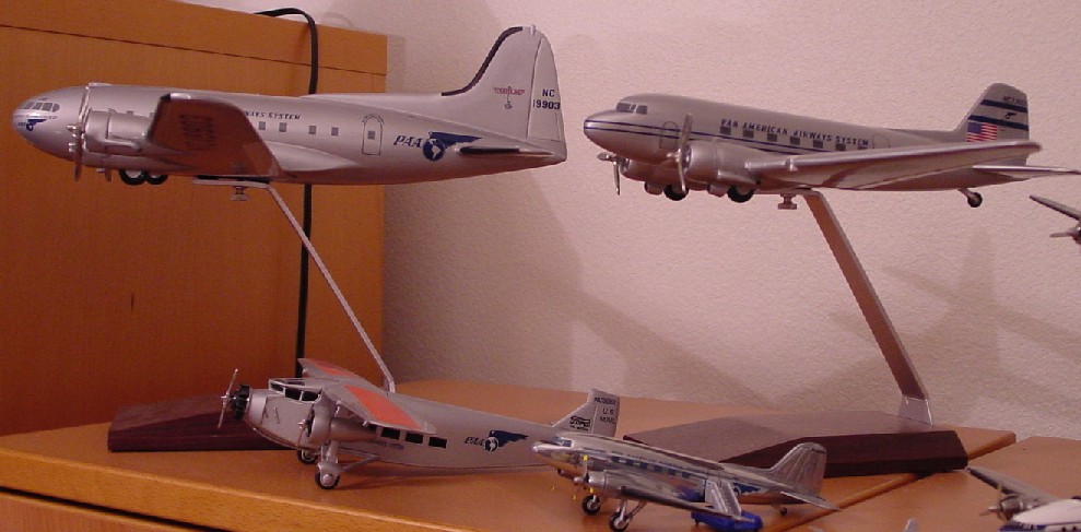 On top the model on the left is a Pan American Boeing 307 Sratoliner.  On the top right is a Pan American Douglass DC3.  Both of these models were produced by Atlantic Models in Florida.  Below left is the Ford Trimotor and on the right another example of the DC3.  The smaller DC 3 was produced by the famous English toy car manufacturer Corgi.